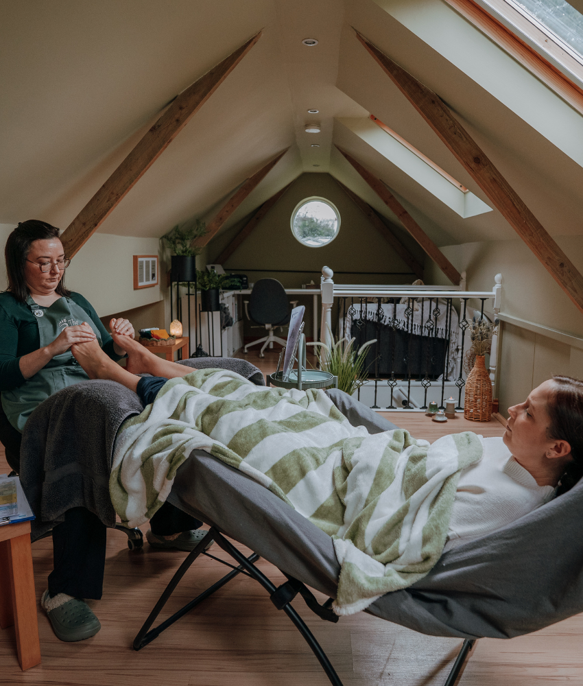 reflexology_treatments Claire Ball with a client during a reflexology session
